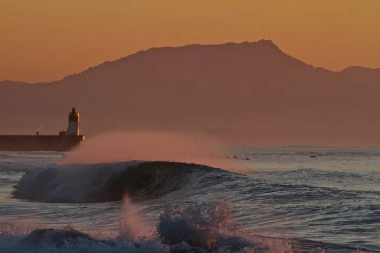 De grosses vagues agitent la mer devant le phare de Capbreton.